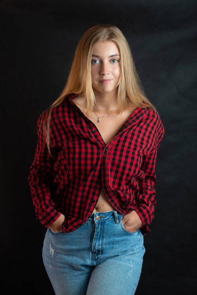 Portrait of beautiful woman with blue eyes in black-red shirt. - Foto, imagen