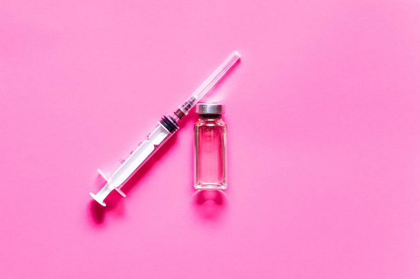 Medicine vial and syringe. Vacctination session and immunity improvement. Flat lay - Фото, изображение