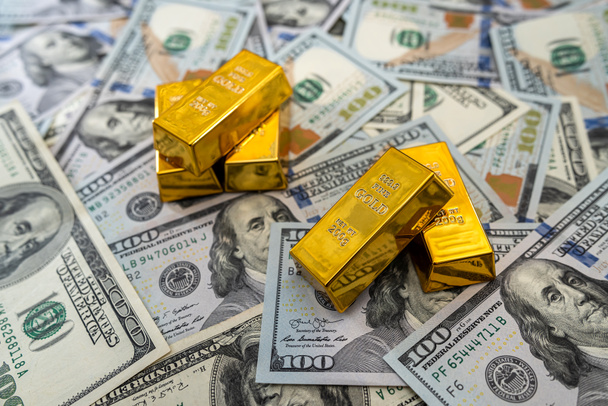 lingotti d'oro su noi mucchio dollari bollette come sfondo. concetto di finanza e risparmio - Foto, immagini