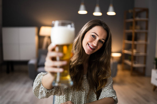 Woman Drinking Beverage Beer In Video Conference At Home - Photo, Image