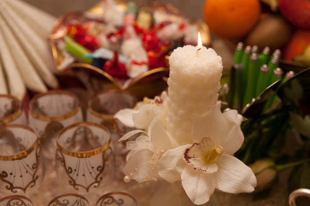 Burning candle with orchid on the festive table - Photo, Image