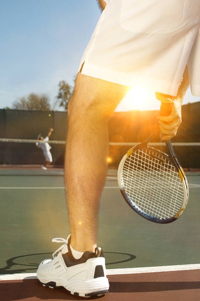 Portrait of tennis player playing on court - 写真・画像