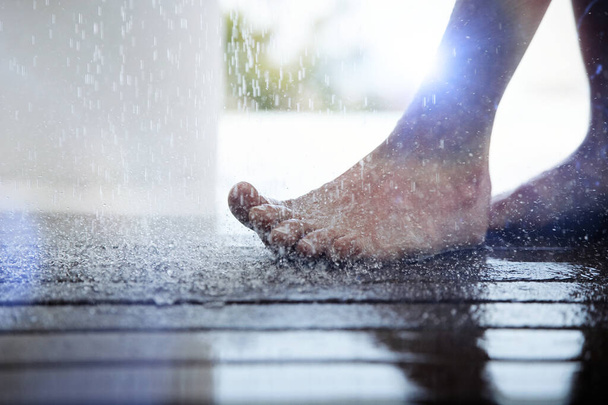 Close up photo of Foot Under Dripping Water - 写真・画像