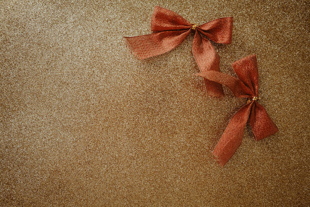 beautiful golden shiny background with red bows - Photo, Image