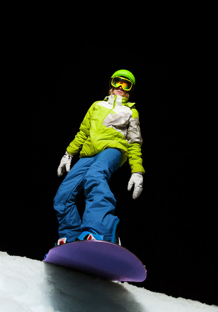 Girl ready to slide with snowboard down the mountain - Zdjęcie, obraz