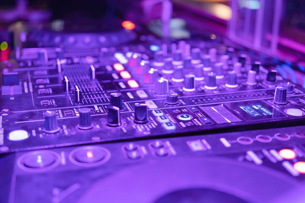Mixes on CD players or track at nightclub during party for DJ. Nightlife of disco club in disco pub club bar background for party music dancing festival performance. Entertainment nightlife. - Photo, image