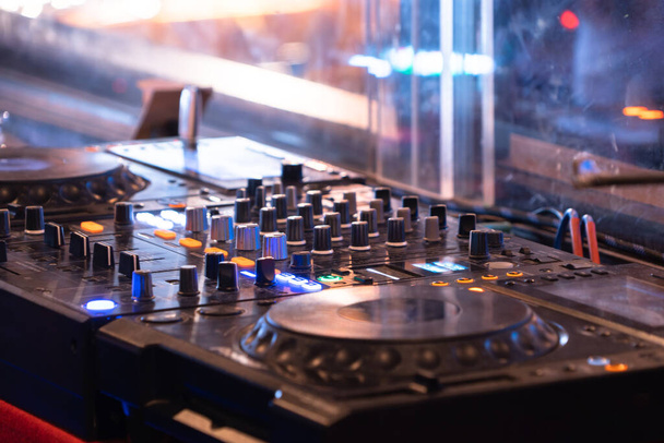 Mixes on CD players or track at nightclub during party for DJ. Nightlife of disco club in disco pub club bar background for party music dancing festival performance. Entertainment nightlife. - Photo, Image