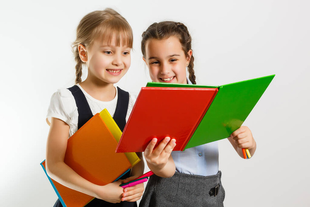 Two little schoolgirls. Education, fashion, friendship concept. - Photo, Image