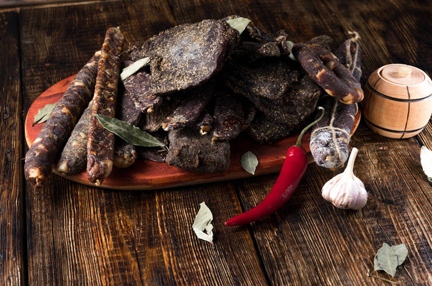 Dried meat of various shapes. Soaked meat in spices. Spices and condiments. - Photo, Image