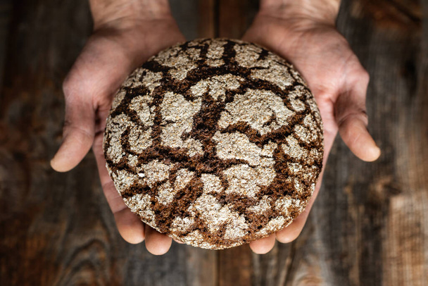 Bread in the human hands. - Foto, Imagen