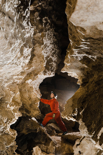 Ένα πορτραίτο ενός νεαρού θηλυκού σπηλαίου που εξερευνά τη σπηλιά. - Φωτογραφία, εικόνα