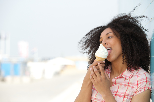 Young woman licking ice cream  - 写真・画像