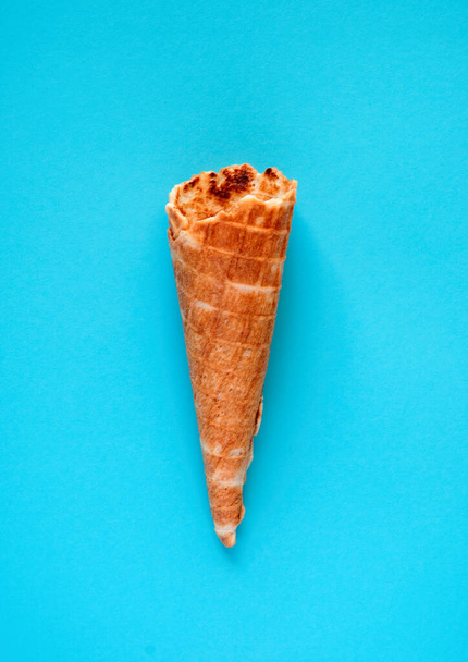 Waffle cone. Ice cream cone close-up on a blue surface. - Foto, Imagem