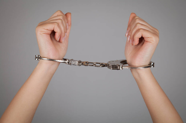 Woman hands handcuffs in criminal concept. - Photo, Image