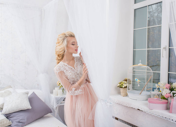 Young beauty fashion bride on bed decor with bouquet of flowers in her hands. Beautiful Bride portrait wedding makeup and hairstyle. Fashion bride model in luxury wedding dress. gorgeous beauty bride. - Photo, Image