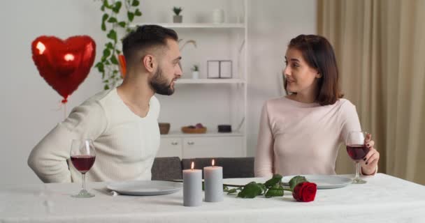 Caucasian couple having dinner drinking wine talking holiday date, boyfriend makes proposal to woman gives ring, proposes to marry him, girlfriend takes positive decision says yes, man and woman hug - Footage, Video
