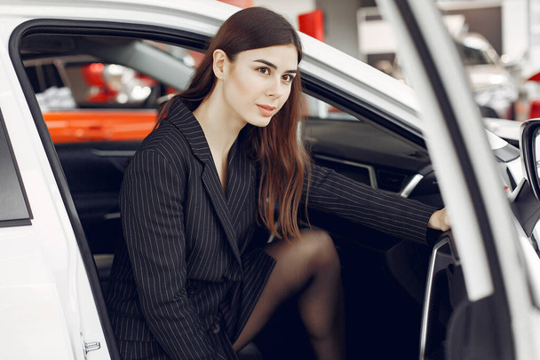 Stylish and elegant woman in a car salon - Fotó, kép