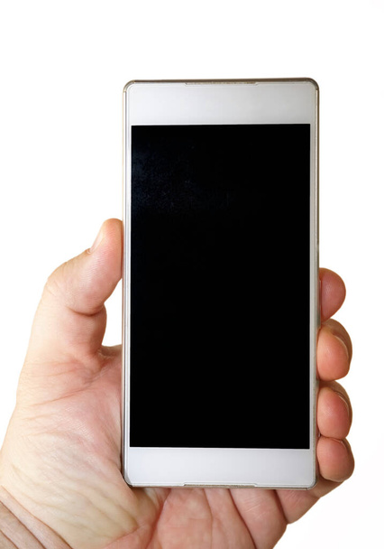 Man hand holding black smartphone isolated on white background, clipping path - 写真・画像