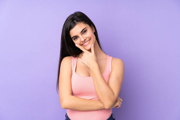 Young woman over isolated purple background smiling - Fotó, kép
