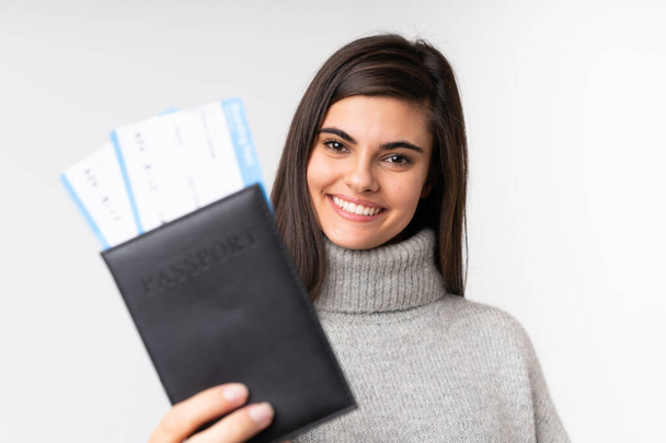 Young woman holding a passport over isolated background - Fotoğraf, Görsel