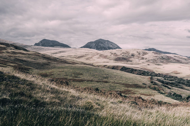Panorámás kilátás nyílik a völgyre közel a legmagasabb hegycsúcs Paps of Jura (Beinn an ir) alatt a sötét vihar ég. Drámai felhők. Jura sziget, Belső-Hebridák, Skócia, Egyesült Királyság. Légköri táj. - Fotó, kép