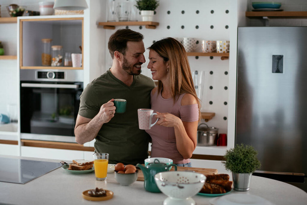 happy couple having breakfast in the kitchen  - Fotografie, Obrázek
