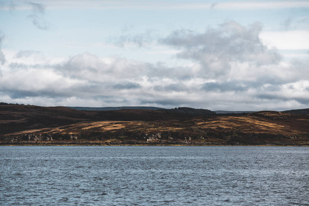 Panoramic view of the rocky shores of Tarbert under dramatic sky. Scotland, UK. Travel destinations, national landmark, recreation, eco tourism, vacations, adventure, exploring - Photo, Image