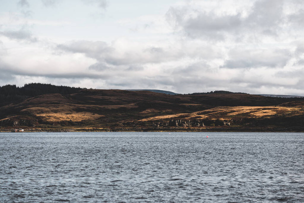 Panoramic view of the rocky shores of Tarbert under dramatic sky. Scotland, UK. Travel destinations, national landmark, recreation, eco tourism, vacations, adventure, exploring - Photo, image