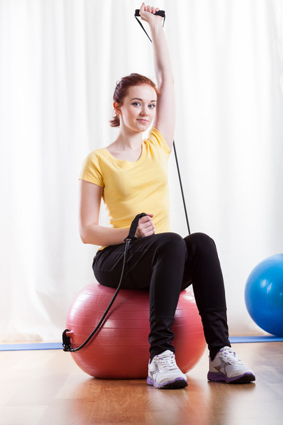 Woman practising at fitness room - Фото, изображение