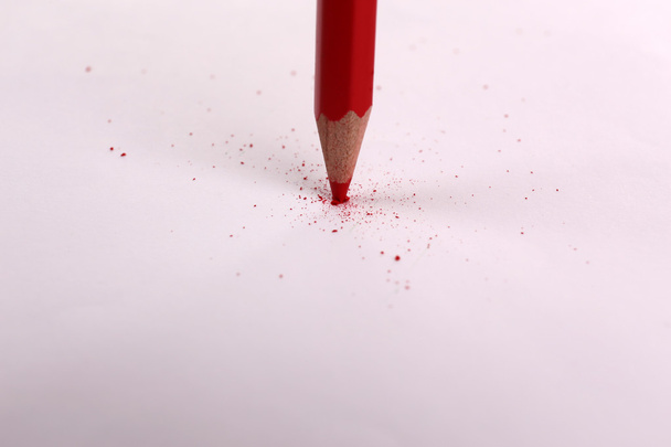 Breaking pencil on paper, close up - Фото, изображение