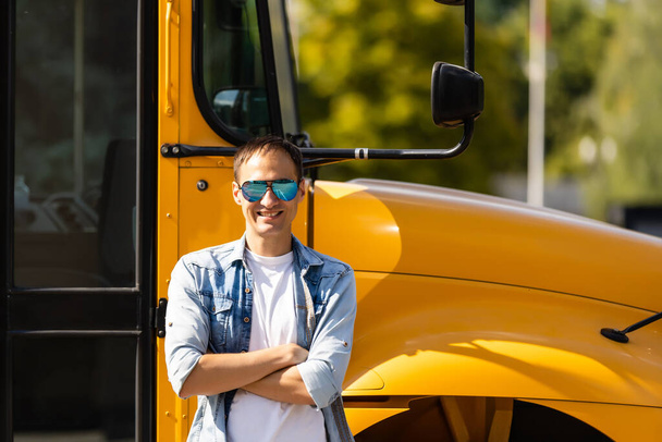 Retrato del profesor sonriente cerca del autobús escolar - Foto, imagen