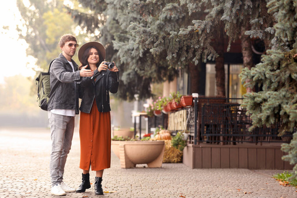 Couple of travelers with camera on city street - Fotó, kép