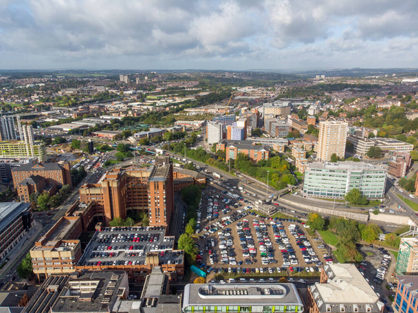 Aerial photo taken on the centre of Leeds in the UK, showing the typical British town centre along with hotels, businesses and shopping centres, taken on a bright sunny part cloudy day - Fotoğraf, Görsel