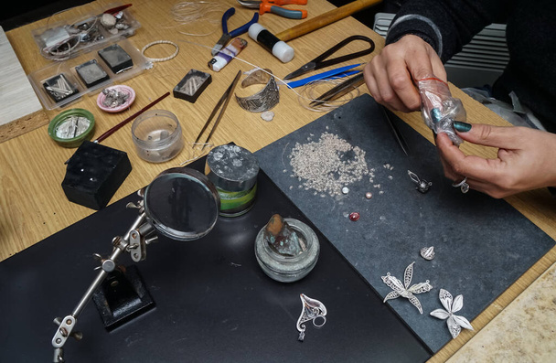 Process of making silver filigree. Production and making manufacturing, factory, cast craft design, process precious silver jewelry, filigree, ring jeweler, silversmith in workshop. - Foto, immagini