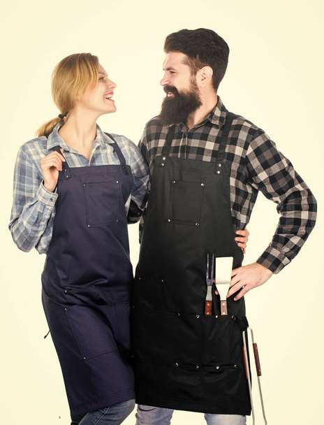 Family cooking grilled food. Cooking together. Couple in love getting ready for barbecue. Man bearded guy and girl ready for barbecue white background. Picnic and barbecue. Backyard barbecue party - 写真・画像