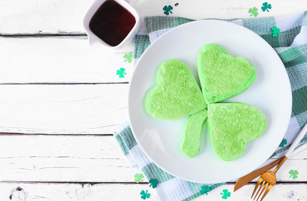 St Patricks Day shamrock pancakes. Top view table scene on a white wood background with copy space. - Photo, Image