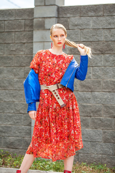 Portrait of a stylish model in long red flowers dress - Foto, Imagem