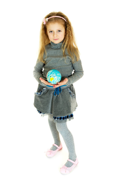 Cute girl holding small globe in her hands - Foto, afbeelding