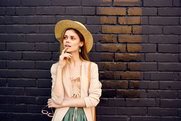 elegant woman in hat walking fresh air brick black wall - Foto, Bild