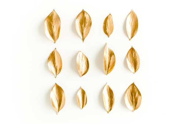 Pattern, texture with gold leaves isolated on white background. flat lay, top view - 写真・画像