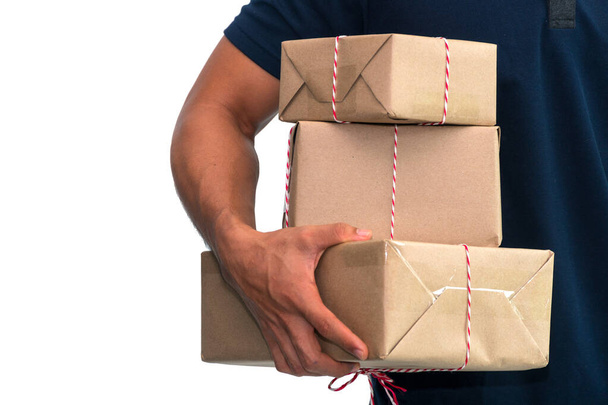Close up delivery man holding three parcel, ready to deliver on white background. Business and logistic concept. - Фото, зображення