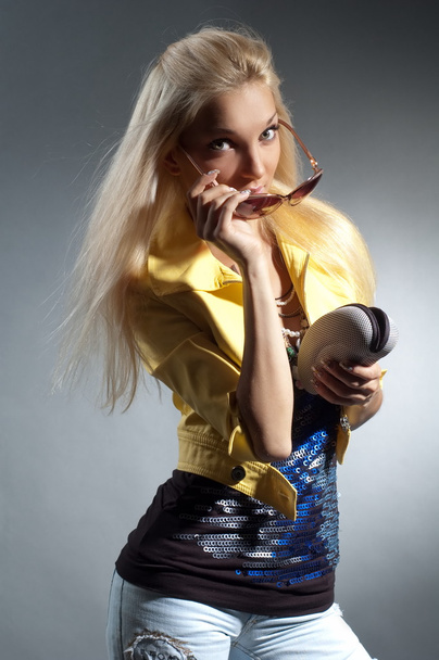 Blond girl in ragged jeans - 写真・画像