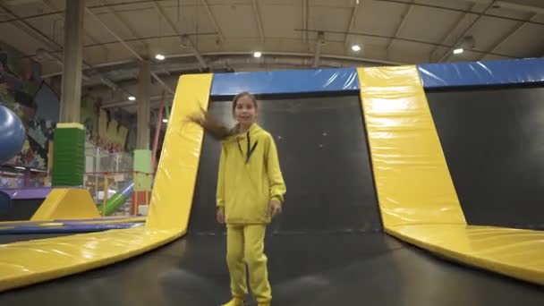 Children active leisure. Sports weekend in sports center of acrobatics and trampoline. Physical education. Children having fun on trampoline in entertainment center, childhood and sporty lifestyle - Footage, Video