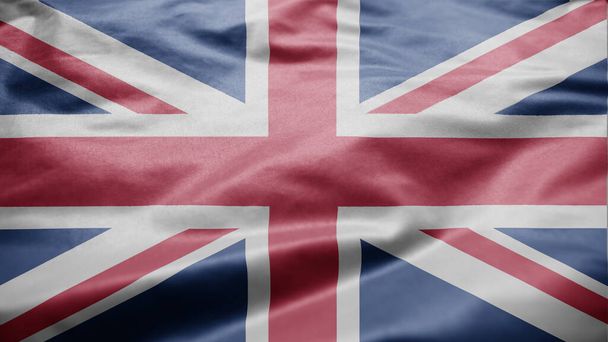 Yhdistyneen kuningaskunnan lippu heiluu tuulessa. Lähikuva Britannian banneri puhaltaa, pehmeä ja sileä silkki. Kankaalla kangas rakenne aliluutnantti tausta. Käytä sitä kansallisen päivän ja maan otteeseen käsite. - Valokuva, kuva