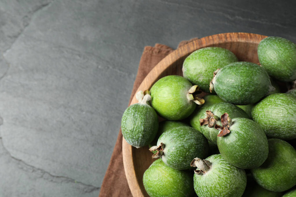 Delicious fresh feijoas on black table, above view. Space for text - Foto, immagini