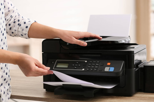 Employee using modern printer in office, closeup - Fotó, kép