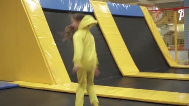 Children active leisure. Sports weekend in sports center of acrobatics and trampoline. Physical education. Children having fun on trampoline in entertainment center, childhood and sporty lifestyle - Footage, Video