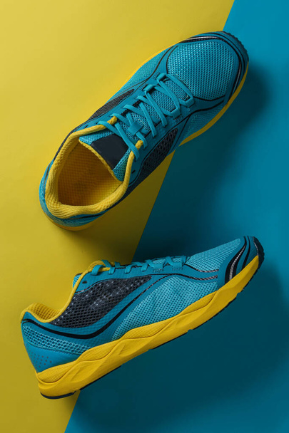 Blue Running boots top view. sport shoes with a Blue and Yellow background with copy space on the right - Photo, Image