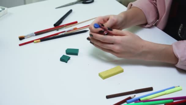 Top view of woman makes something with plasticine at the table - Footage, Video