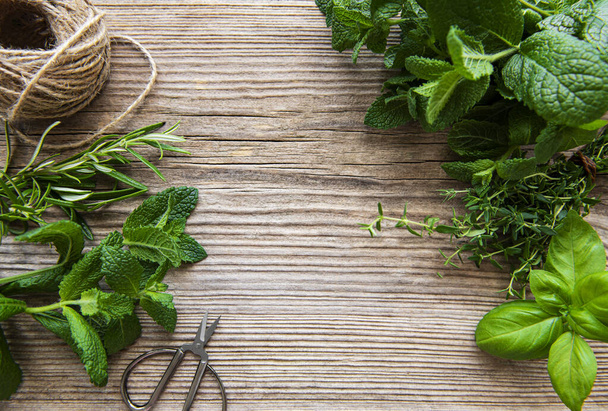 Mix of fresh herbs from garden on an old table - Photo, Image